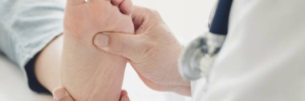 Doctor giving a patient foot treatment